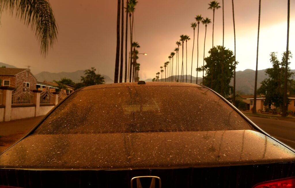AZUZA, CALIFORNIA SEPTEMBER 9, 2020-Ash falls ona parked car as the Bobcat Fire burns in the distance Wednesday morning. (Wally Skalij/Los Angeles Times)